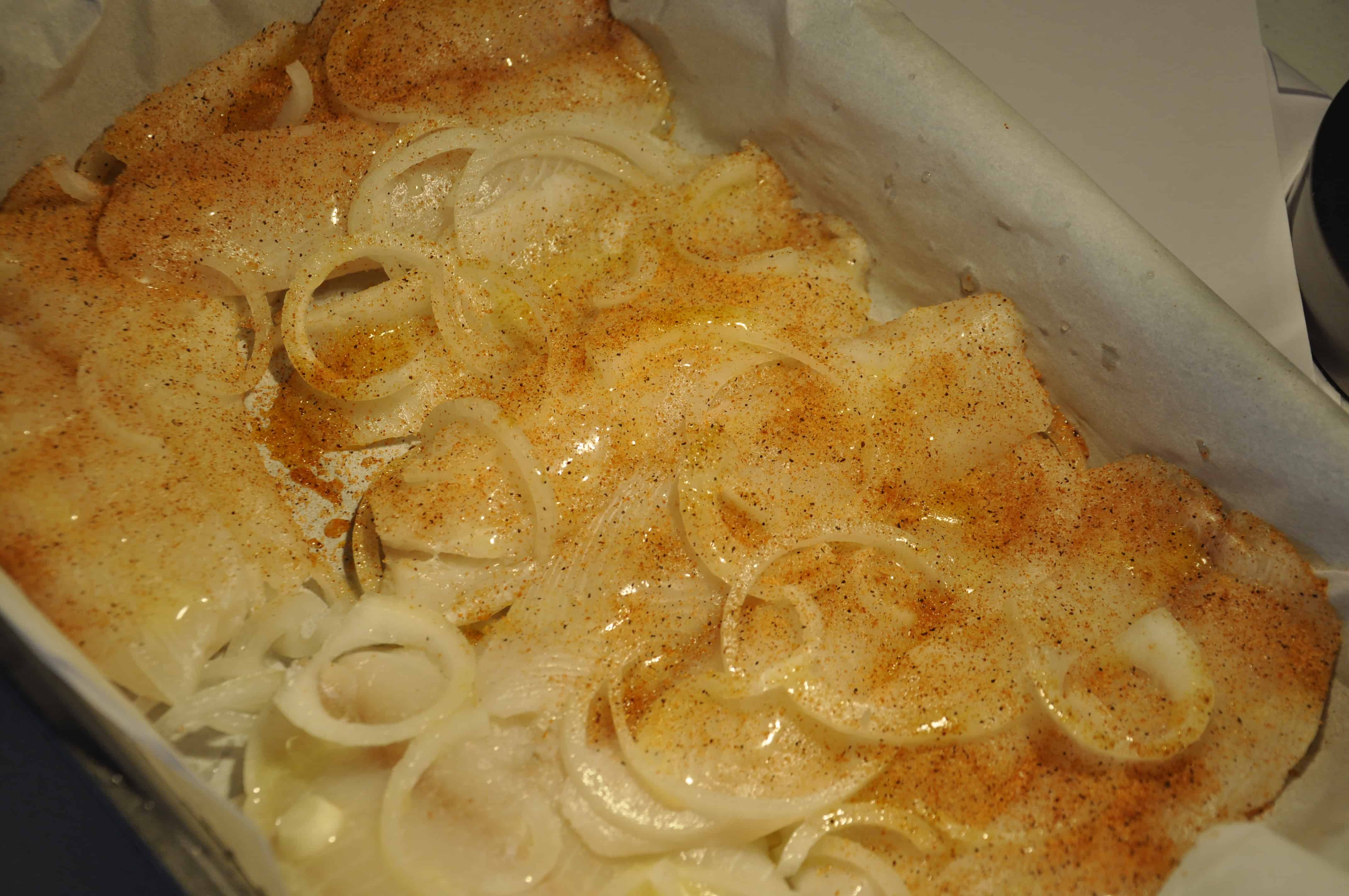 gluten free baked tilapia on a bed of sweet onions from knowtgluten.me