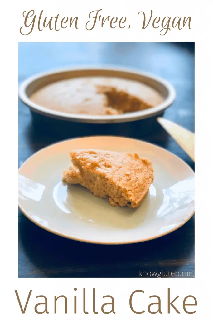 A piece of gluten free vegan vanilla cake on a white and teal plate in front of a cake pan.