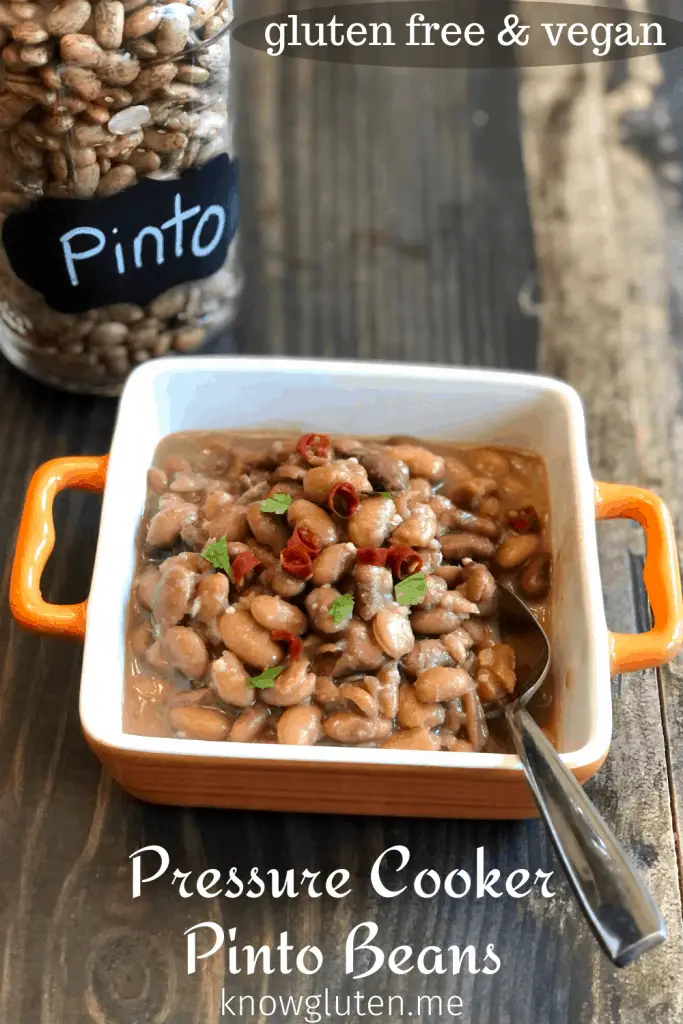 a bowl of pinto beans beside a jar of dried pinto beans