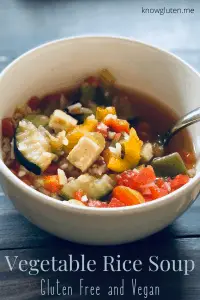 gluten free, vegan vegetable rice soup in a bowl on a wood table