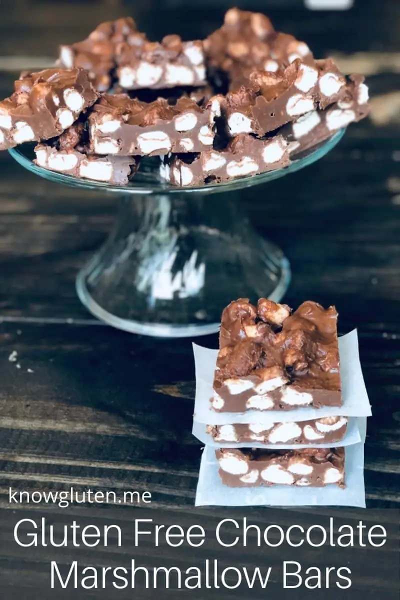 Chocolate marshmallow bars on a serving tray with a stack of marshmallow bars in front.