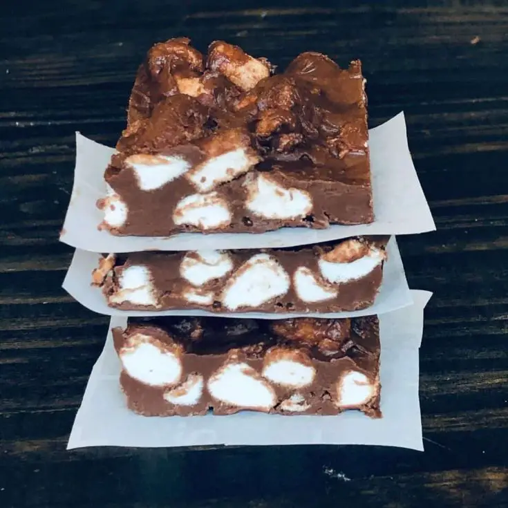 A closeup of chocolate marshmallow bars stacked up.