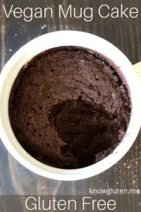 A chocolate vegan mug cake with a spoonful missing.
