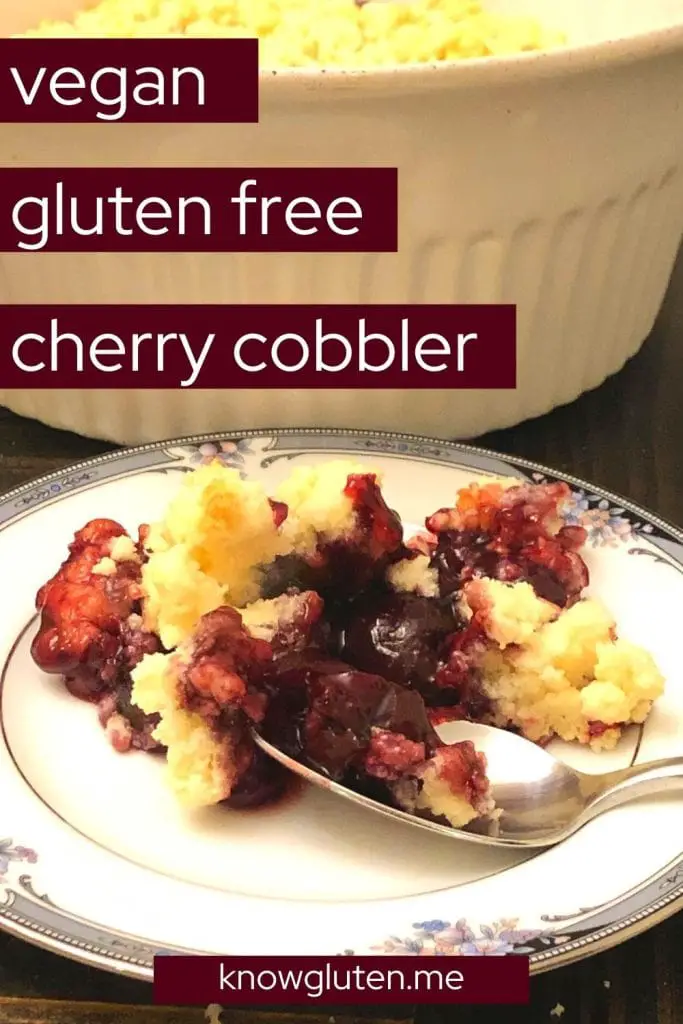 gluten free cherry cobbler on a plate with a spoon in front of a baking dish.