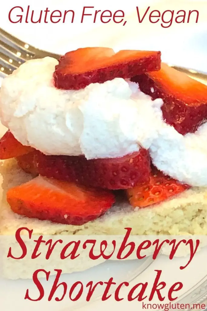 Closeup of gluten free strawberry shortcake on a plate with a fork in the background.