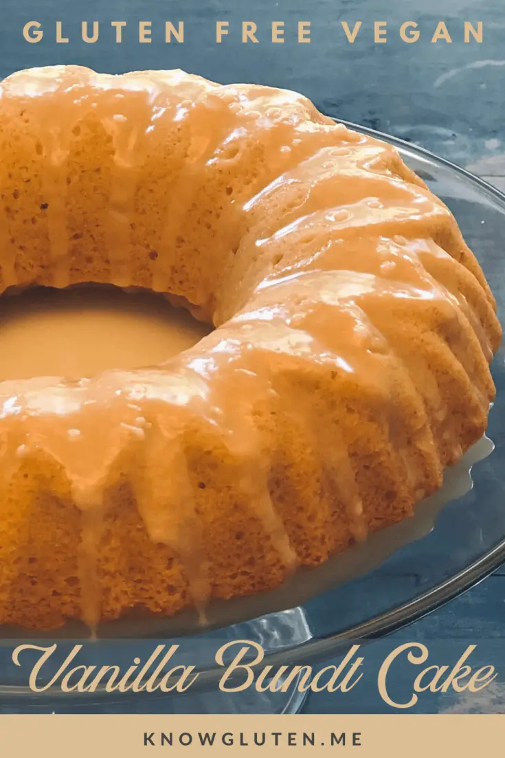 A closeup of a gluten free vanilla bundt cake with a glaze on a glass serving tray.