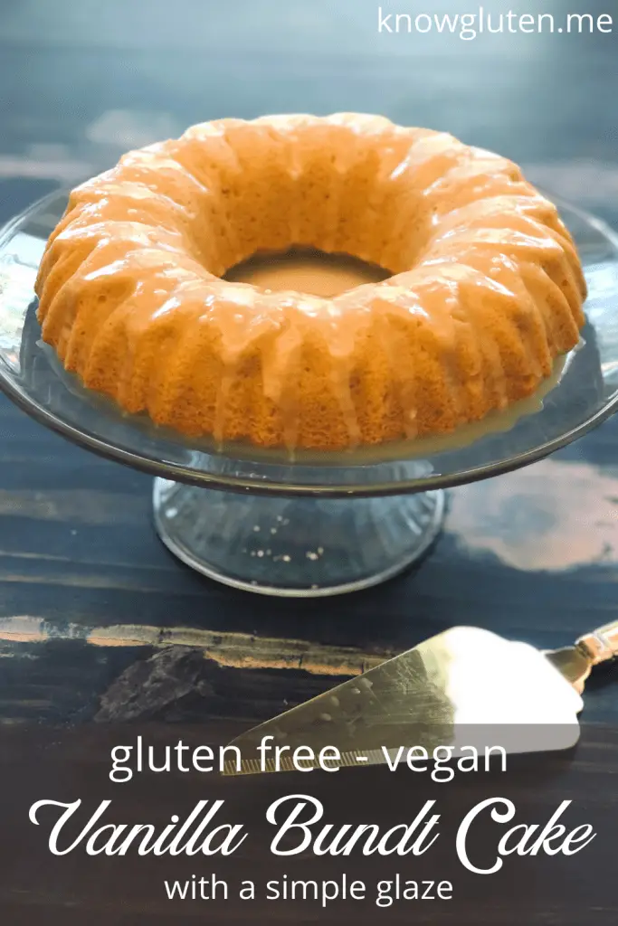 Gluten Free Vanilla Bundt Cake on a serving tray on a wood table with a gold cake server.