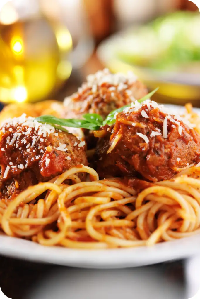gluten free vegan meatballs on a bed of spaghetti with garnish